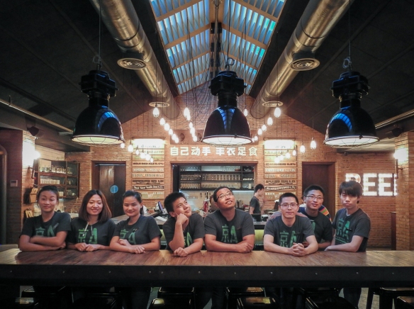 Staff pose at 京A Brewery's flagship bar and restaurant in Beijing.